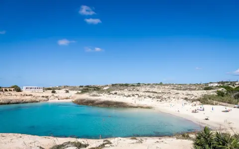 Una baia con acque cristalline e sabbia dorata, tra le migliori spiagge di Lampedusa. Un paradiso terrestre.
