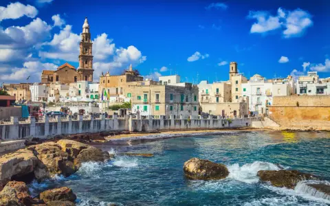 Vista sul mare di Bari Vecchia, con case bianche e torri che si affacciano sull'acqua cristallina. Un luogo incantevole da vedere.