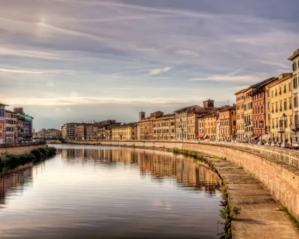 Lungarno a Pisa, con palazzi colorati che si specchiano nel fiume. Un'atmosfera da fiaba, tra Lucca e Pisa.