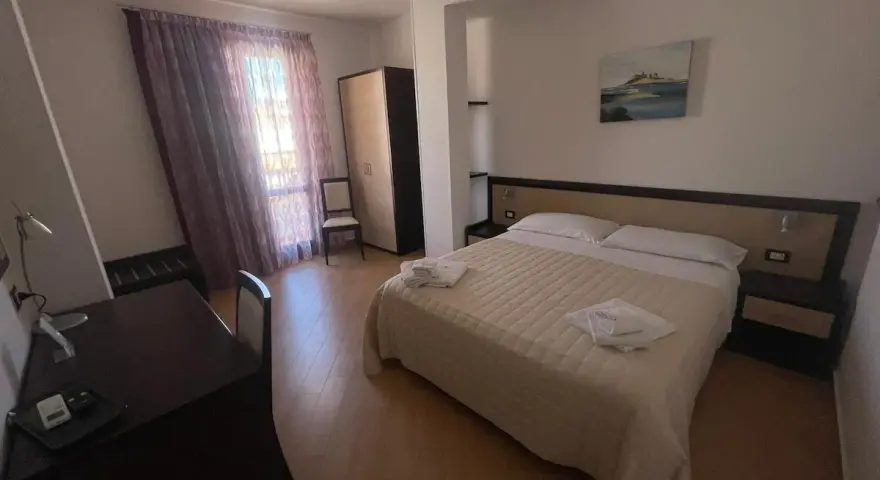 Camera accogliente nella pensione Scala a Portopalo, con letto comodo, armadio e scrivania.