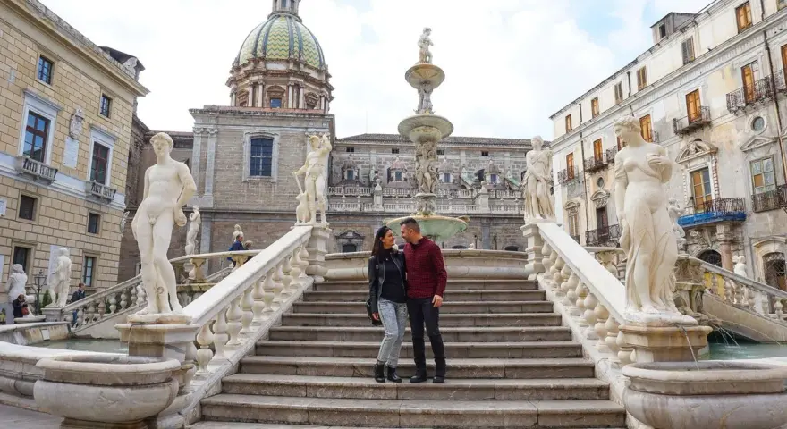 Coppia felice alla Fontana Pretoria, un'attrazione imperdibile per ogni itinerario a Palermo.