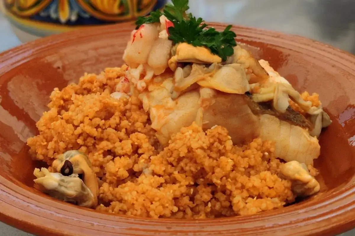 Piatto di couscous con pesce e cozze, un'ottima idea su cosa mangiare a Trapani.