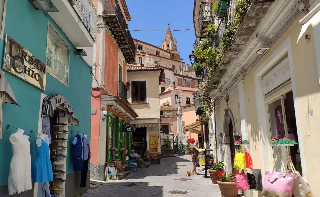 Maratea centro storico cosa vedere: vicoli colorati, negozietti e scorci pittoreschi con la torre campanaria in lontananza.